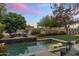 Inviting pool area with elegant tile and lush landscaping, offering a serene outdoor retreat with golf course views at 6929 E Montreal Pl, Scottsdale, AZ 85254