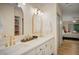 Bathroom with double vanity, stylish mirrors, modern lighting, and neutral decor at 7412 S Elm St, Tempe, AZ 85283