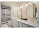 Bright bathroom with a double vanity, framed mirrors and shower with decorative tile at 7412 S Elm St, Tempe, AZ 85283