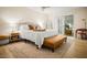 Relaxing bedroom with large bed, leather bench, decorative rug and access to outdoor seating area at 7412 S Elm St, Tempe, AZ 85283