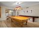 Bright game room showcasing a billiards table and game table with hardwood style floors at 7412 S Elm St, Tempe, AZ 85283
