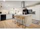 Modern kitchen with white cabinets, stainless steel appliances, and a large island with seating at 7412 S Elm St, Tempe, AZ 85283