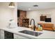 Modern kitchen featuring an island, countertops, and sleek appliances, with an open view to the living room at 7412 S Elm St, Tempe, AZ 85283