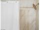 Bright shower with white marble-style tile, white shower curtain and bronze hardware at 7412 S Elm St, Tempe, AZ 85283