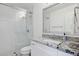 Modern bathroom featuring a walk-in shower with glass door and granite countertop with white cabinets at 7694 E Minnezona Ave, Scottsdale, AZ 85251