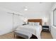 Bright bedroom featuring modern sliding door, ceiling fan, and bench at the foot of the bed at 7694 E Minnezona Ave, Scottsdale, AZ 85251