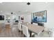 Open-concept dining area with sleek table, modern light fixture, and living room view at 7694 E Minnezona Ave, Scottsdale, AZ 85251