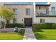 Charming home featuring a well-maintained lawn and a private balcony overlooking lush greenery at 7694 E Minnezona Ave, Scottsdale, AZ 85251