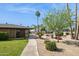 Exterior view of a building surrounded by a grassy area, trees, and a walkway at 7694 E Minnezona Ave, Scottsdale, AZ 85251