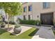 Inviting front entrance boasting lush landscaping, manicured greenery, and an elegant brick pathway at 7694 E Minnezona Ave, Scottsdale, AZ 85251