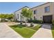Attractive front entrance highlighting a neat lawn, elegant brick details, and mature landscaping for a serene welcome at 7694 E Minnezona Ave, Scottsdale, AZ 85251