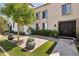 Welcoming front entrance showcasing a well-maintained lawn, brick accents, and lush greenery at 7694 E Minnezona Ave, Scottsdale, AZ 85251
