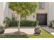 Charming front entrance with a brick pathway, manicured hedges, and stylish planters flanking the doorway at 7694 E Minnezona Ave, Scottsdale, AZ 85251