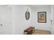 Hallway with a bench, mirror, and poster adding character to the space at 7694 E Minnezona Ave, Scottsdale, AZ 85251