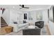 Cozy living room with a modern ceiling fan, plantation shutters, and stylish decor at 7694 E Minnezona Ave, Scottsdale, AZ 85251