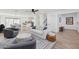 Bright living room with wood-look floors, a ceiling fan, a white sofa, and gray accent chairs at 7694 E Minnezona Ave, Scottsdale, AZ 85251