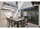 Private patio with outdoor dining setup and sliding door creating a seamless indoor-outdoor flow at 7694 E Minnezona Ave, Scottsdale, AZ 85251
