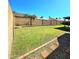 Spacious backyard with a lush lawn, brick trim and block fence for privacy at 8512 W Tuckey Ln, Glendale, AZ 85305