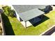 Aerial view of backyard featuring grass, covered patio and mature trees at 8512 W Tuckey Ln, Glendale, AZ 85305