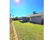 View of backyard with grass, brick trim and covered patio at 8512 W Tuckey Ln, Glendale, AZ 85305