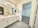 Bright bathroom features a single sink vanity with a mirror and an attached walk-in closet at 8512 W Tuckey Ln, Glendale, AZ 85305