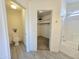 A view of the bathroom with the toilet on the left and the shower and walk-in closet straight ahead at 8512 W Tuckey Ln, Glendale, AZ 85305