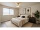 Well-lit bedroom boasts neutral decor, soft carpet, and contemporary artwork at 8512 W Tuckey Ln, Glendale, AZ 85305