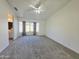 Spacious primary bedroom with large window and neutral carpet at 8512 W Tuckey Ln, Glendale, AZ 85305