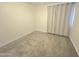 Empty bedroom with neutral carpet, light walls, and window for natural light at 8512 W Tuckey Ln, Glendale, AZ 85305