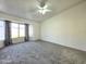 Spacious primary bedroom with large window and neutral carpet at 8512 W Tuckey Ln, Glendale, AZ 85305