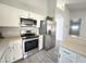This kitchen features stainless steel appliances and white cabinets at 8512 W Tuckey Ln, Glendale, AZ 85305