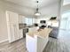 Modern kitchen with island, stainless steel appliances, and ample cabinet space at 8512 W Tuckey Ln, Glendale, AZ 85305