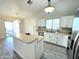 Bright kitchen featuring white cabinets, stainless steel appliances, and an island at 8512 W Tuckey Ln, Glendale, AZ 85305
