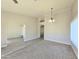 Open-concept living room featuring vaulted ceilings, carpeted floors and tile entryway at 8512 W Tuckey Ln, Glendale, AZ 85305