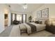 Spacious main bedroom with plush carpets, bay windows, and an ensuite bathroom at 8512 W Tuckey Ln, Glendale, AZ 85305