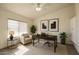 Cozy office space featuring neutral colors, large windows, and a comfortable armchair at 8512 W Tuckey Ln, Glendale, AZ 85305