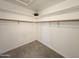 Walk-in closet with shelves and a hanging rod to keep clothes and accessories neatly organized at 8512 W Tuckey Ln, Glendale, AZ 85305