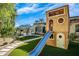 Custom wooden play structure with slide and outdoor seating area enhance the property's backyard at 8601 N 59Th Pl, Paradise Valley, AZ 85253