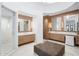 Luxurious bathroom with dual vanities, marble countertops, custom cabinetry, a walk-in shower, and elegant lighting at 8601 N 59Th Pl, Paradise Valley, AZ 85253