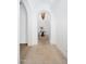 Elegant hallway featuring an arched entryway, hardwood floors, and a decorative light fixture at 8601 N 59Th Pl, Paradise Valley, AZ 85253