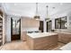 Spacious laundry room with custom cabinetry, a large island, modern appliances, and ample counter space at 8601 N 59Th Pl, Paradise Valley, AZ 85253