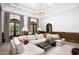 Comfortable living room with a large sofa, wood-paneled accent wall, elegant lighting, and ample natural light at 8601 N 59Th Pl, Paradise Valley, AZ 85253