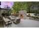 Comfortable outdoor seating area with stone fireplace and a playhouse at 8601 N 59Th Pl, Paradise Valley, AZ 85253