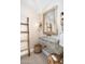 Unique powder room featuring a stone sink, rustic wooden ladder, decorative mirror, and stylish lighting fixtures at 8601 N 59Th Pl, Paradise Valley, AZ 85253