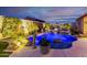 This home's pool features beautiful lighting, rock features, lush landscaping, and a serene outdoor ambiance for relaxation at 9908 E Medina Ave, Mesa, AZ 85209