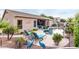 The backyard has a stunning pool with lounge seating and an inviting atmosphere for relaxation and entertainment at 9908 E Medina Ave, Mesa, AZ 85209