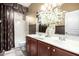 Bathroom featuring double sinks, decorative mirror, and shower-tub combination at 9908 E Medina Ave, Mesa, AZ 85209