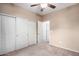 Bedroom with ample closet space, neutral tones, and carpet flooring at 9908 E Medina Ave, Mesa, AZ 85209