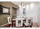 Contemporary dining room featuring a modern table setting, unique wall decor, and ample lighting at 9908 E Medina Ave, Mesa, AZ 85209