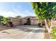 Attractive single-Gathering house shows an extended driveway and a two-car garage at 9908 E Medina Ave, Mesa, AZ 85209